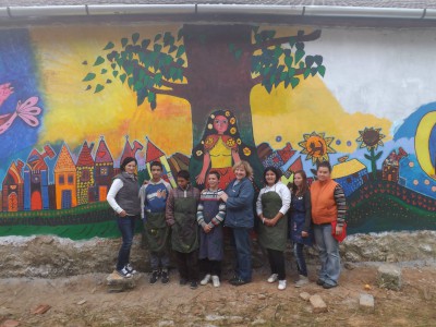Az Igazgyöngy AMI tanulói és a szerző Bódvalenkén az általuk készített falfestmény előtt